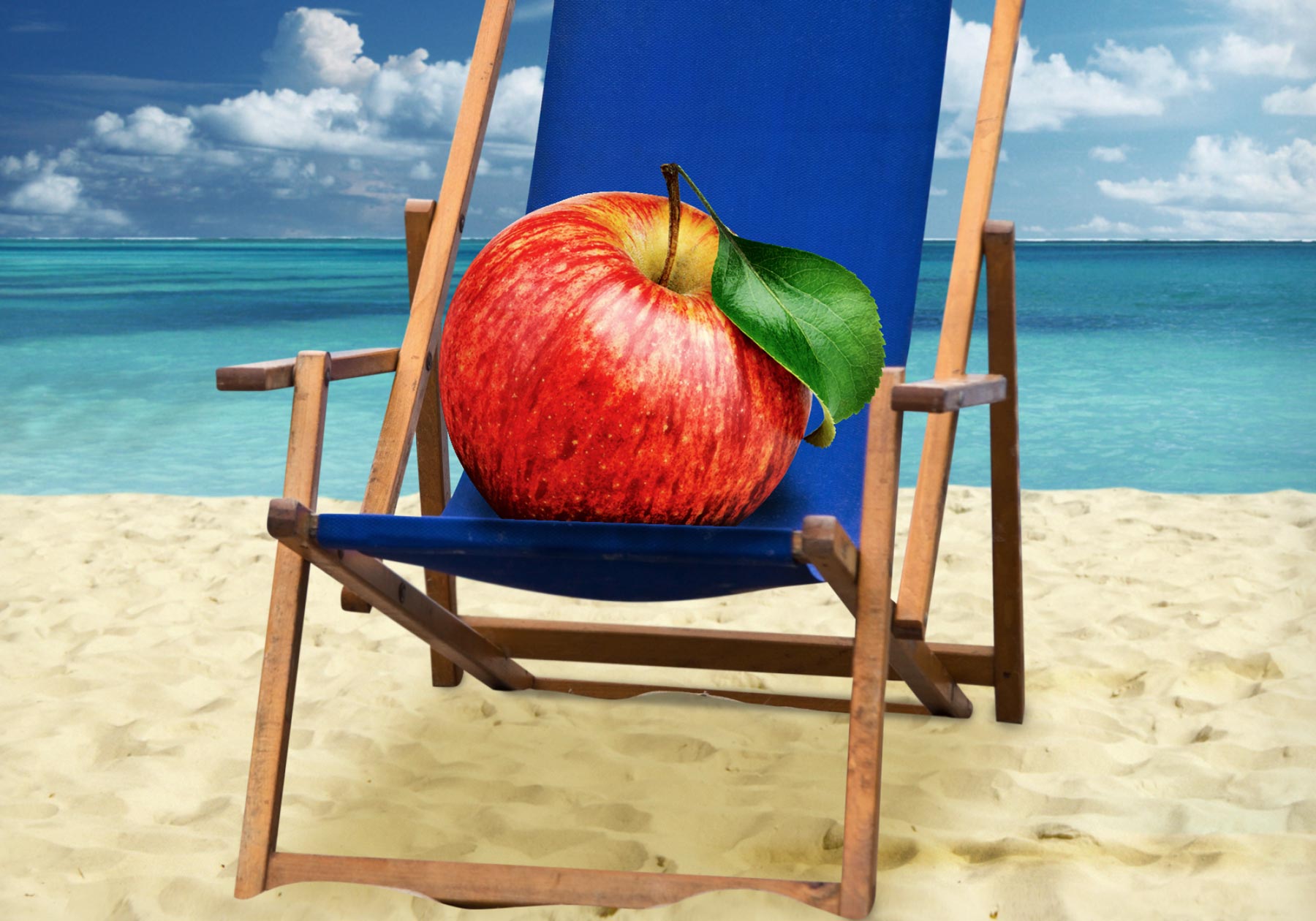 An apple relaxing in a chair on a sunny beach